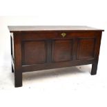 A 19th century oak coffer, with three panelled front and raised on block supports, width 130cm.