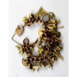 A 9ct gold link charm bracelet with numerous charms to include vintage racing cars, bagpipes,