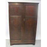 A mid-20th century oak valet compactum gentlemen's wardrobe, named shelves to one side for pyjamas,