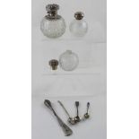 Three ovoid cut glass non-matching dressing table bottles with hallmarked silver collars and tops,