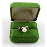 A 14ct yellow gold ladies' dress ring with a brown and cream pearl on a twist, size U, approx 4.4g.