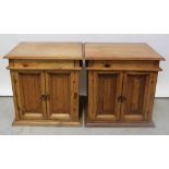 A pair of Mexican pine cabinets with twin panelled doors, 60.5 x 60 x 47.5cm (2).