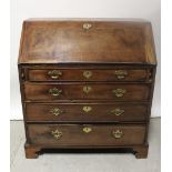 A George III mahogany bureau, the fall-front enclosing fitted interior above four drawers,