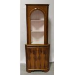 A reproduction yew floor standing corner cabinet,