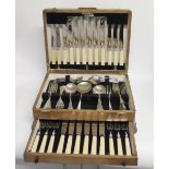 An oak canteen of plated cutlery with lower drawer.