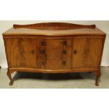 A reproduction yew wood serpentine-front sideboard,