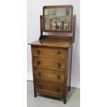 A 1920s/30s oak dressing chest of narrow form, with four central drawers, width 61cm.