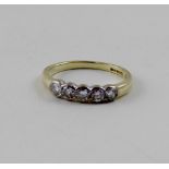 An 18ct yellow gold five-stone collet-set diamond ring, each diamond approx 0.