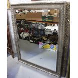 A large contemporary silver-effect framed bevel-edged wall mirror, 117 x 90cm.