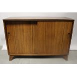 A mid-20th century cabinet with two sliding doors, raised on bracket feet, width 122cm.