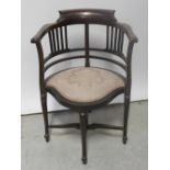 An Edwardian mahogany corner chair with two pierced splats,