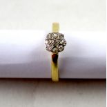 A yellow metal ladies' diamond daisy ring, size V, approx 3.2g.