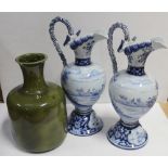 A pair of early 20th century blue and white transfer and hand painted Delft urns,