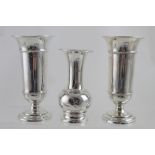 A pair of George V hallmarked silver posy vases, each raised on stepped circular bases,