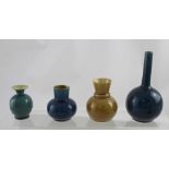 Four Linthorpe Pottery art pottery vases to include a bottle vase with cylindrical neck,