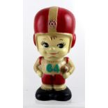 A c1950s Japanese Tatung American boy footballer number 64 money box, height 19.5cm.