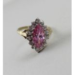 A 9ct yellow gold ladies' dress ring, central marquise-set pink stone with white stone surround,