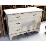 An early 20th century cream painted two-over-two chest of drawers to shaped plinth base,