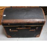 A 19th century black domed-top seaman's trunk with brown leather trim and leather carrying handles,