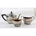 A Victorian hallmarked silver three-piece tea service with silver-gilt interior, comprising teapot,