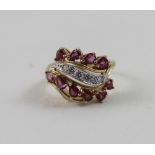 A 14ct yellow gold ladies' dress ring set with ten pink stones and small diamonds,