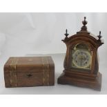 An Edwardian mahogany mantel clock, the silvered dial set with Arabic numerals,