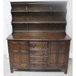 A modern reproduction dark oak dresser, the two-shelf plate rack on dresser base,