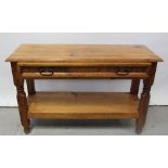 A pine rectangular side table with single long drawer above under tier, on block supports,