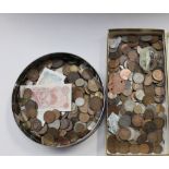 A vintage Cadbury's chocolate biscuit tin containing a quantity of copper and silver coins to