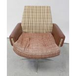 A c1960s swivel chair to a white metal base with quadripartite support,