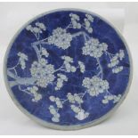 A 19th century Oriental blue and white charger decorated with prunus blossom with bamboo decoration