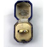 An Edwardian gold dress ring, starburst set with a solitaire diamond, size N, approx 2.3g.