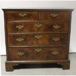 An early 18th century oak and walnut chest of drawers,