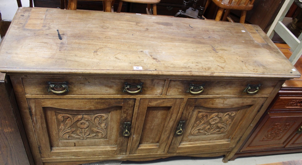 An early 20th century oak sideboard, two frieze drawers above a recessed central panel,