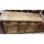 An early 20th century oak sideboard, two frieze drawers above a recessed central panel,