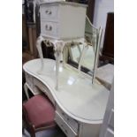 A mirror-back dressing table and a bedside cabinet,