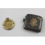 A hallmarked silver vesta case and a 9ct gold medal, both awarded to S L Bennett (2).