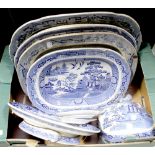 A collection of 19th century blue and white ceramics, predominantly decorated in the Willow pattern,