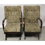 A pair of mid-20th century beechwood-framed rocking chairs, upholstered in floral material (2).