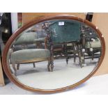 An Edwardian oval mahogany-framed wall mirror, 82cm.