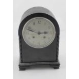 An early 20th century oak-cased eight-day mantel clock, the silvered dial set with Arabic numerals,