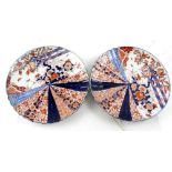 A pair of late 19th/early 20th century Imari chargers, each decorated with sunburst-style panel,