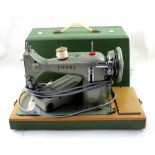 A cased Jones Family CS Model E sewing machine.