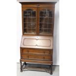 An early 20th century oak Jacobean-style bureau bookcase,
