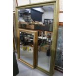 Two similar large contemporary gilt and black framed bevel-edged wall mirrors,