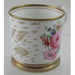 A 19th century porcelain mug decorated with garden sprays and roses,