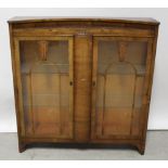 An Art Deco walnut veneered twin-door display cabinet, width 118cm,