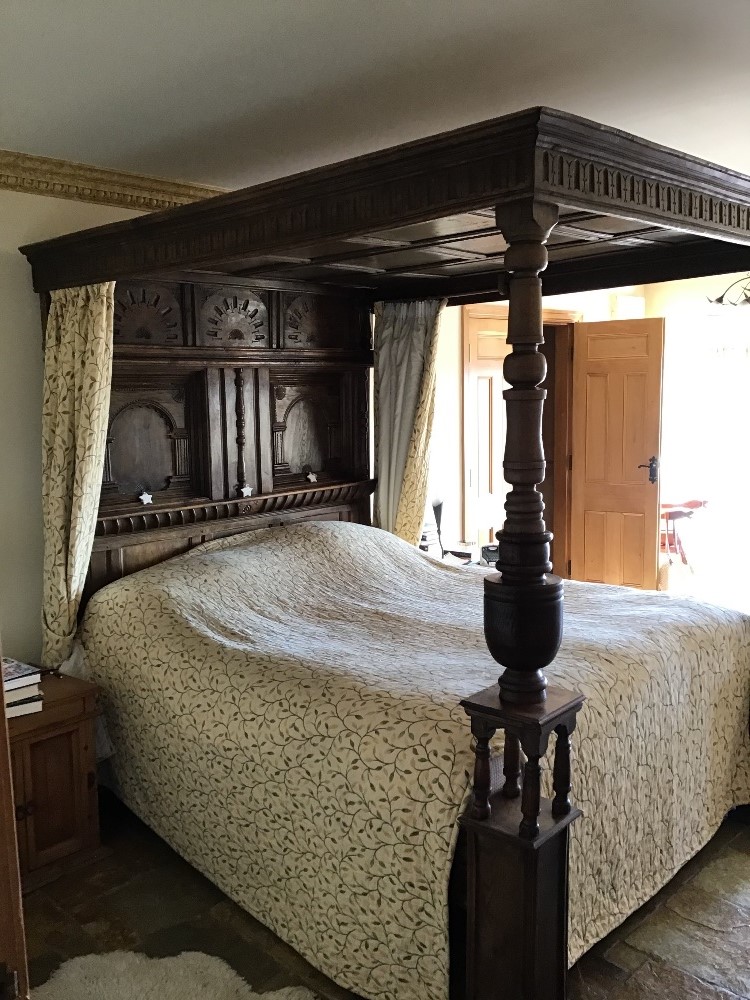 A bespoke Elizabethan-style king size four-poster bed,