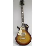 A 'Vintage' V100 reissued left handed electric guitar, Les Paul style in tobacco sunburst finish,