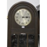 A mid-20th century oak longcase clock, domed top above gilded dial set with Arabic numerals,